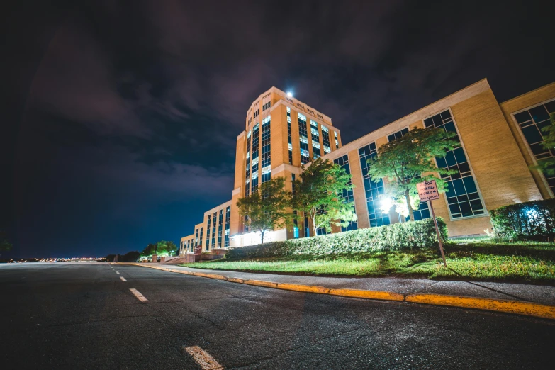 a large building sitting on the side of a road, by Josh Bayer, unsplash, hospital lighting, shot on gopro9, capital plaza, medical complex