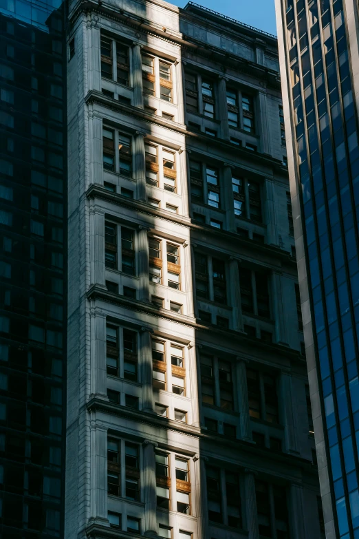 a tall building with a clock on top of it, by Andrew Domachowski, unsplash contest winner, dappled afternoon sunlight, chicago, reflections. shady, ignant