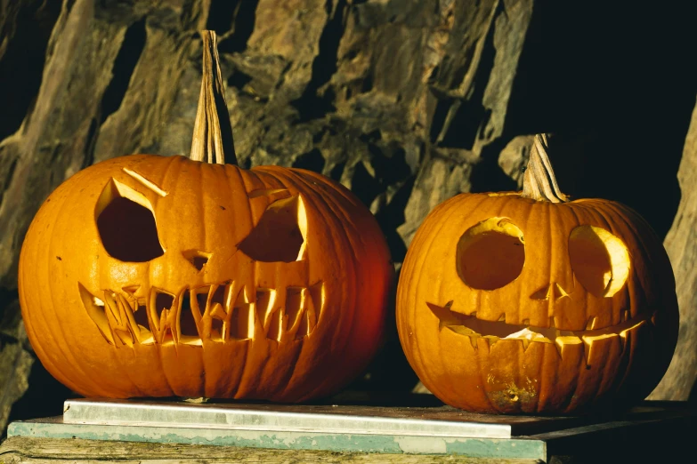 two carved pumpkins sitting next to each other, pexels, vanitas, large fangs, 2 0 0 0's photo, getty images, graham humphreys