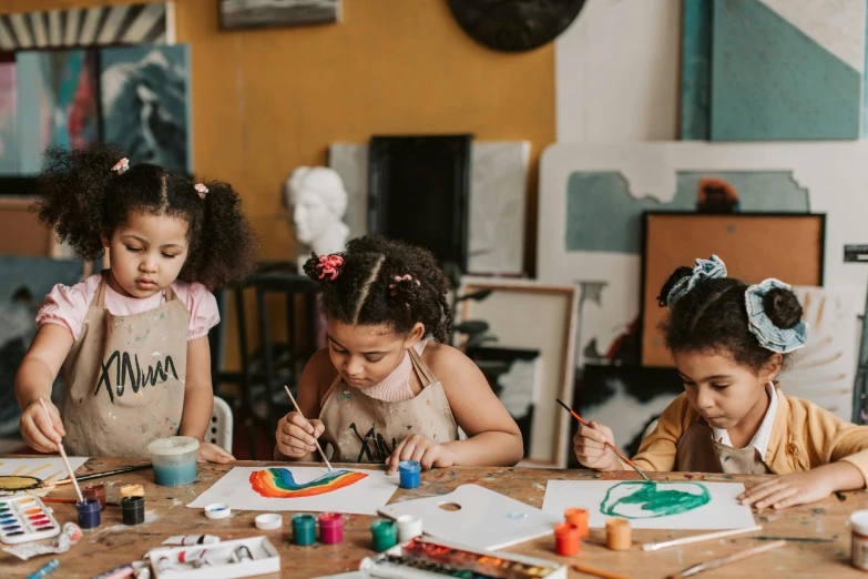 a group of children sitting around a wooden table, a child's drawing, pexels contest winner, black arts movement, painting a canvas, realistic cute girl painting, music video, portrait featured on unsplash