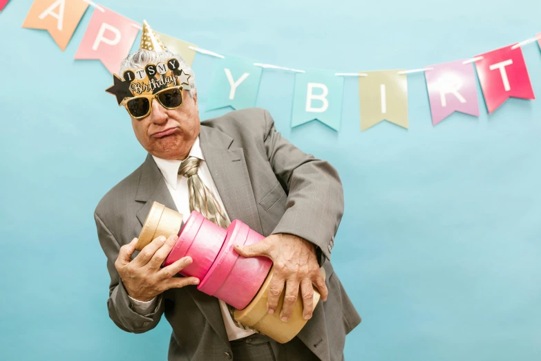 a man in a suit holding a birthday cake, an album cover, shutterstock, wrinkles, party balloons, elderly, implanted sunglasses