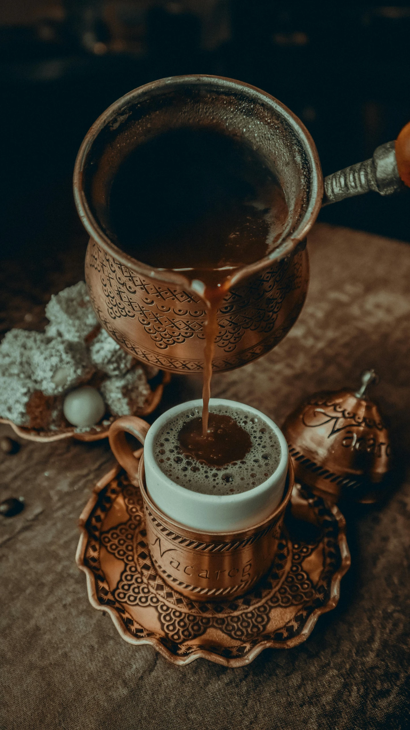 a cup of coffee sitting on top of a saucer, by irakli nadar, pexels contest winner, hurufiyya, made of bronze, pouring, mixture turkish and russian, vintage shading