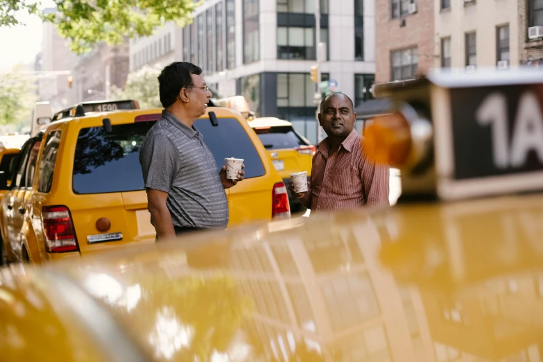 a couple of men standing next to a yellow taxi, happening, jemal shabazz, square, thumbnail