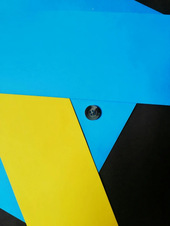 a blue and yellow skateboard sitting on top of a black surface, a poster, inspired by Frederick Hammersley, unsplash, geometric abstract art, detail shot, magnetic, 2 0 1 4, uniform off - white sky