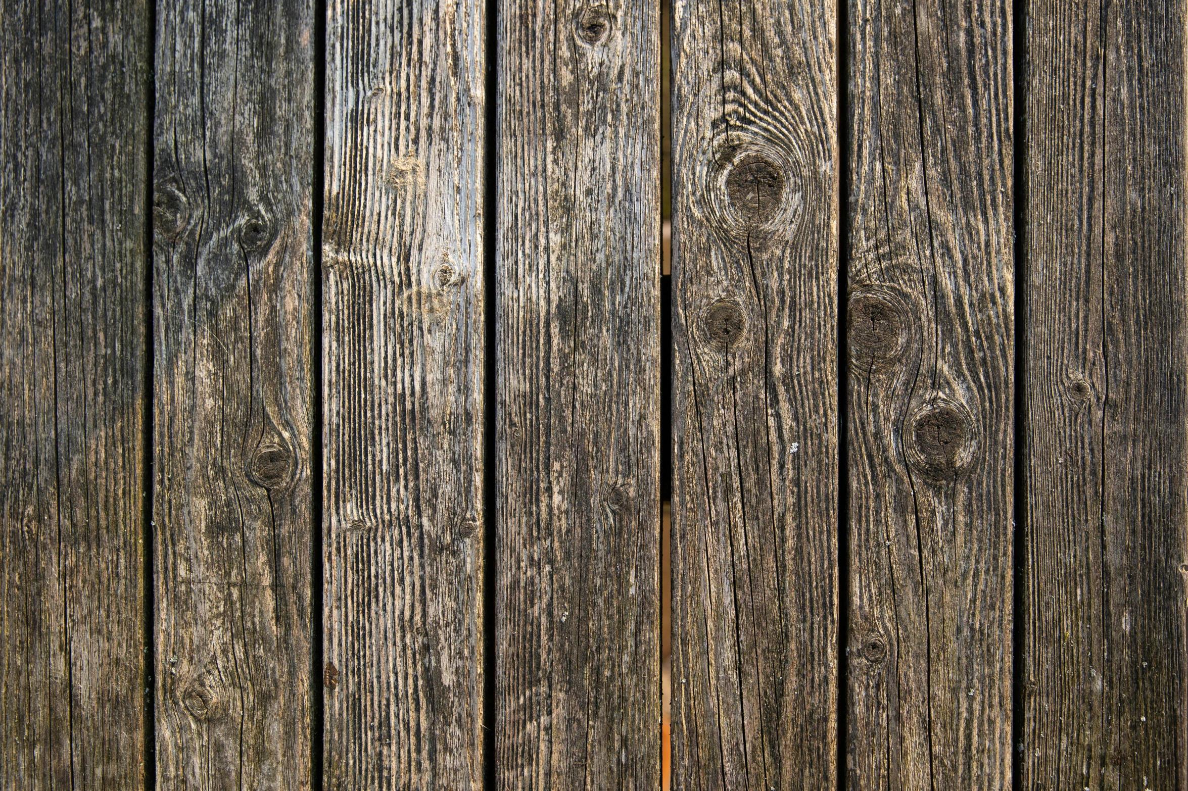 a fire hydrant sitting on top of a wooden fence, pexels, renaissance, seamless wood texture, black vertical slatted timber, 17th-century, stubbles
