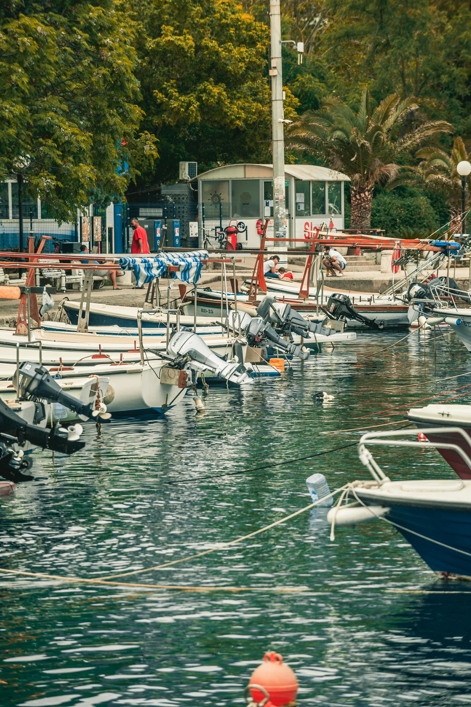 a number of small boats in a body of water, greece, square, colored photo, high quality picture