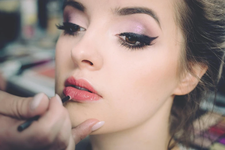 a woman is getting her make up done, by Joe Bowler, trending on pexels, winged eyeliner, sexy lips :5 stylish, portrait close - up, uploaded