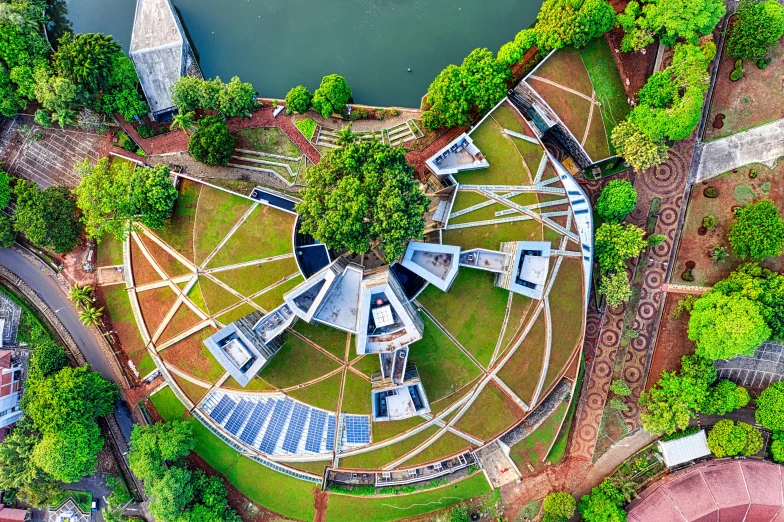 an aerial view of a circular building surrounded by trees, inspired by Tadao Ando, pexels contest winner, solar sails, sri lanka, an exquisite 3 d map, national archives