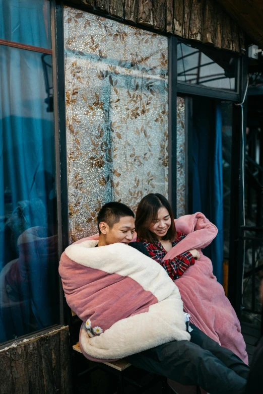 a man and a woman sitting on a window sill, trending on unsplash, happening, sleeping bag, ruan jia and fenghua zhong, embracing, sitting in a cafe