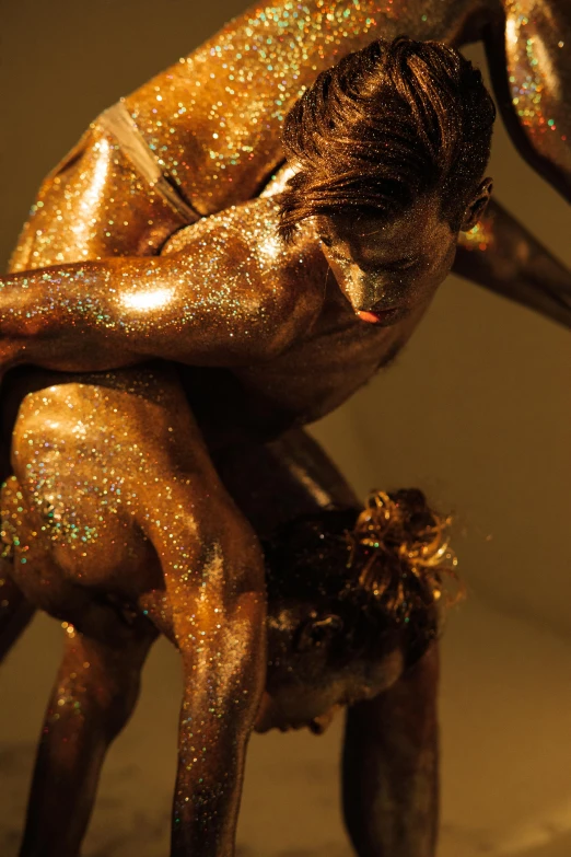 a close up of a statue of a person on a horse, inspired by Umberto Boccioni, gold flakes, beefcake pose, kiss, performance