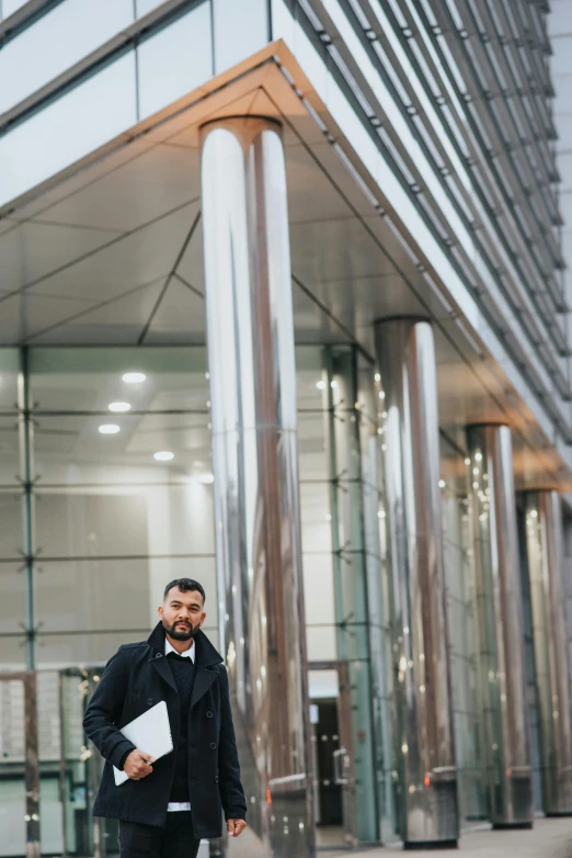 a man standing in front of a glass building, london gang member, professional photo, post graduate, man walking