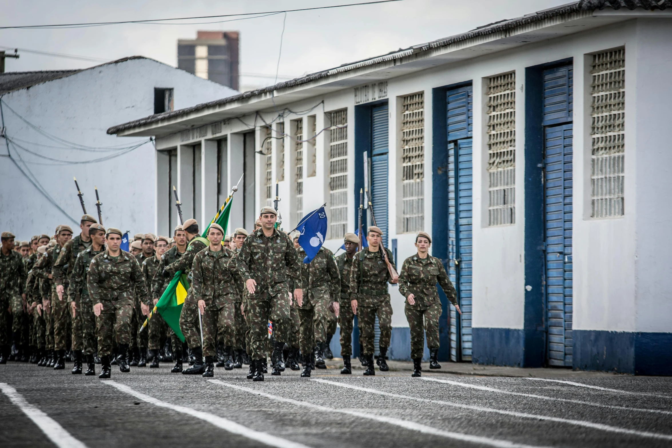 a group of soldiers marching down a street, a photo, by João Artur da Silva, avatar image, azores, camo, maintenance photo