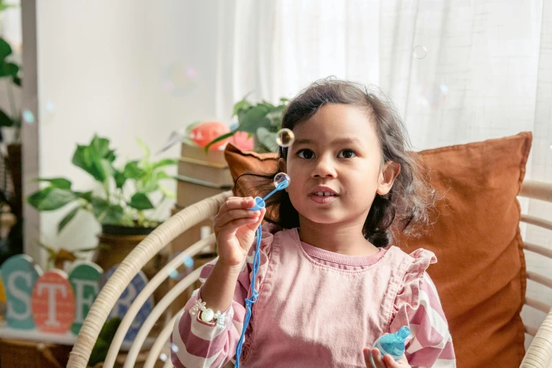 a little girl sitting in a chair holding a toothbrush, inspired by Sophie Gengembre Anderson, pexels contest winner, soap bubbles, sapphire butterfly jewellery, with a stethoscope, nebulizer equipment