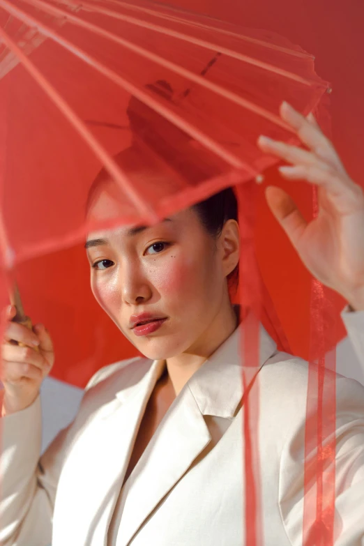 a woman holding a red umbrella over her head, inspired by Gao Qipei, pexels contest winner, magic realism, translucent skin, kiko mizuhara, beauty campaign, asian man