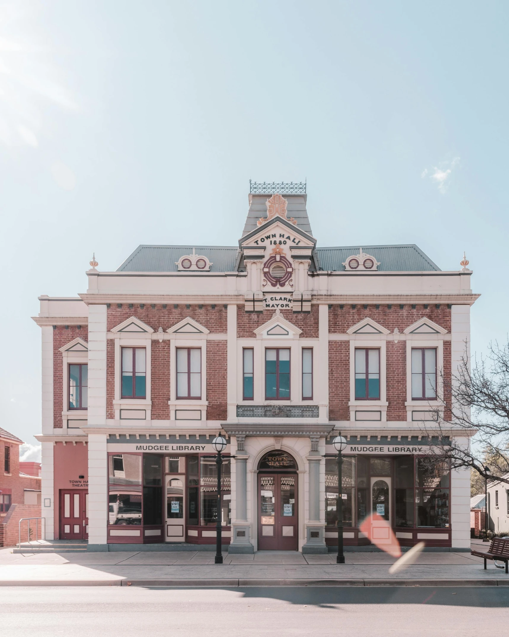 a red and white building sitting on the side of a road, inspired by George Pirie, pexels contest winner, art nouveau, theater, old west town, front elevation view, manuka