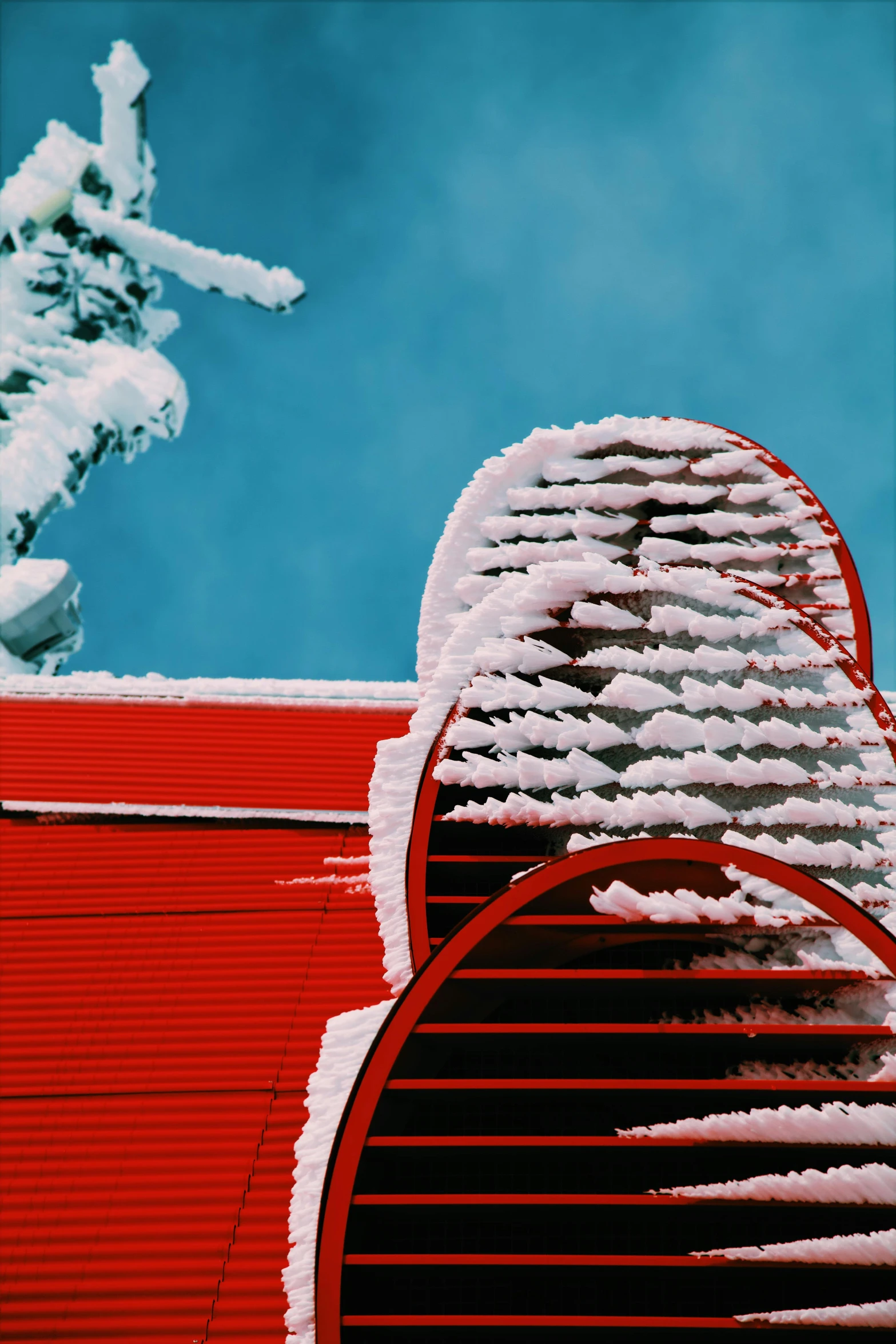a red fire hydrant covered in snow next to a statue, an abstract sculpture, by Doug Ohlson, roofs, shutters, stunning ski, colour photograph