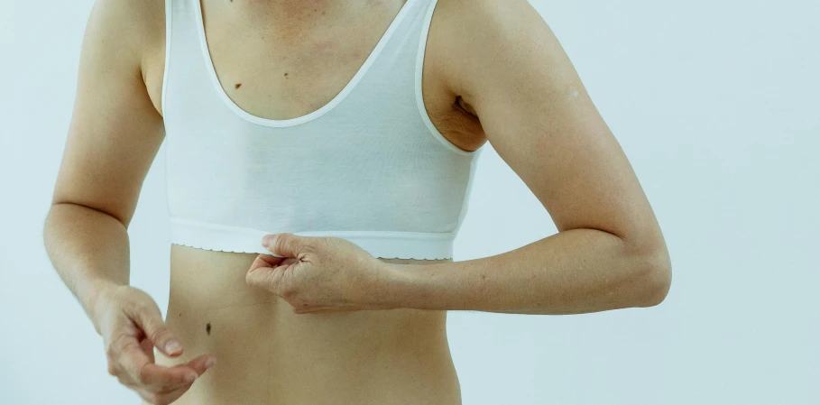 a close up of a person in a white shirt, plasticien, sports bra, surgery, half body cropping, full body image
