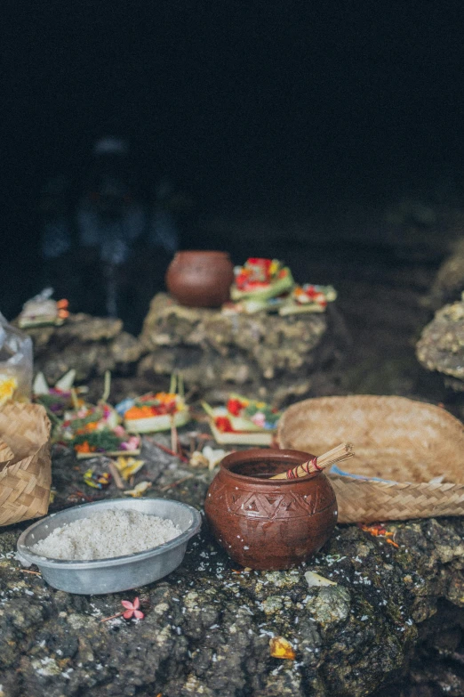 a bunch of food sitting on top of a rock, a still life, ayahuasca ceremony, in an ancient tomb, slide show, promotional image