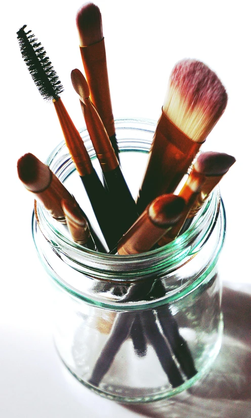 a jar filled with makeup brushes sitting on top of a table, pexels, made of bamboo, indi creates, studio photograph, ilustration