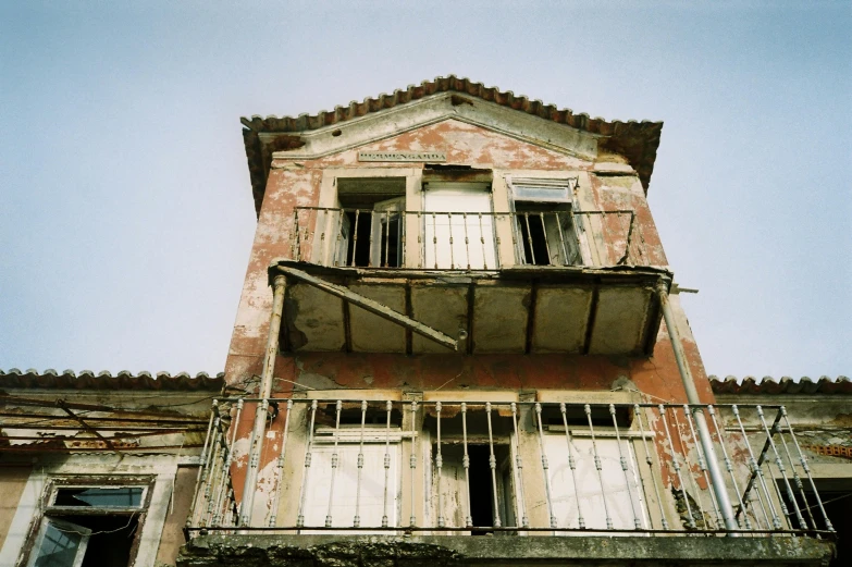 an old building with a balcony and balconies, an album cover, unsplash, greece, haunted kodachrome, 2000s photo, 'untitled 9 '