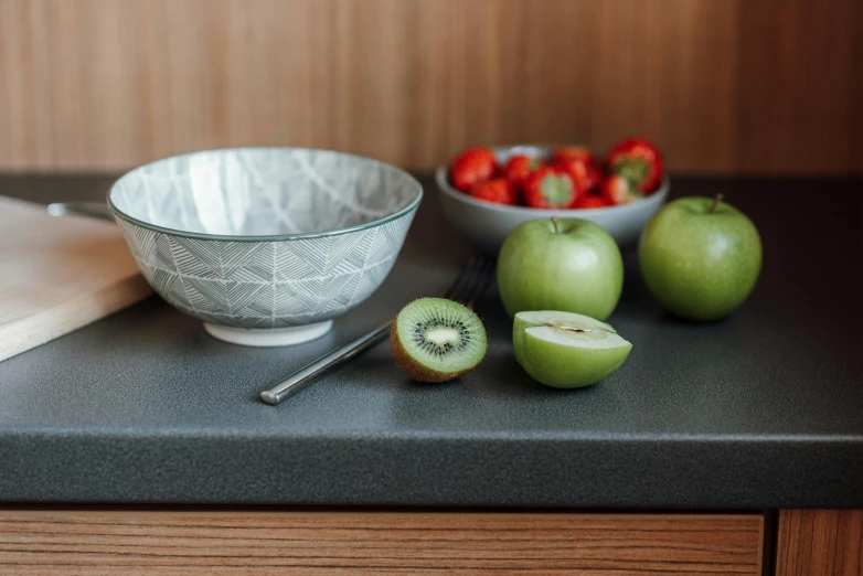 a close up of a bowl of fruit on a counter, inspired by Constantin Hansen, unsplash, figuration libre, light grey mist, patterned, slate, japanese collection product