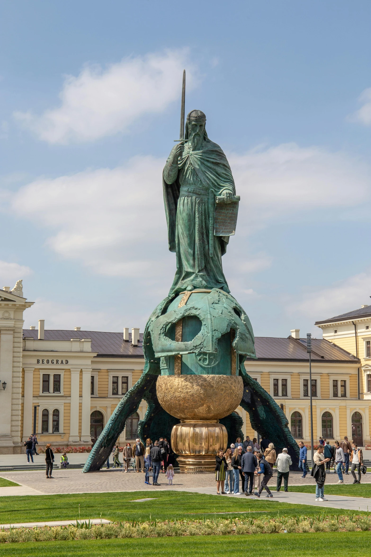 a statue of a woman holding a sword in front of a building, a statue, inspired by Károly Markó the Elder, octopus wrestling with a sphere, gold, green, crowded square