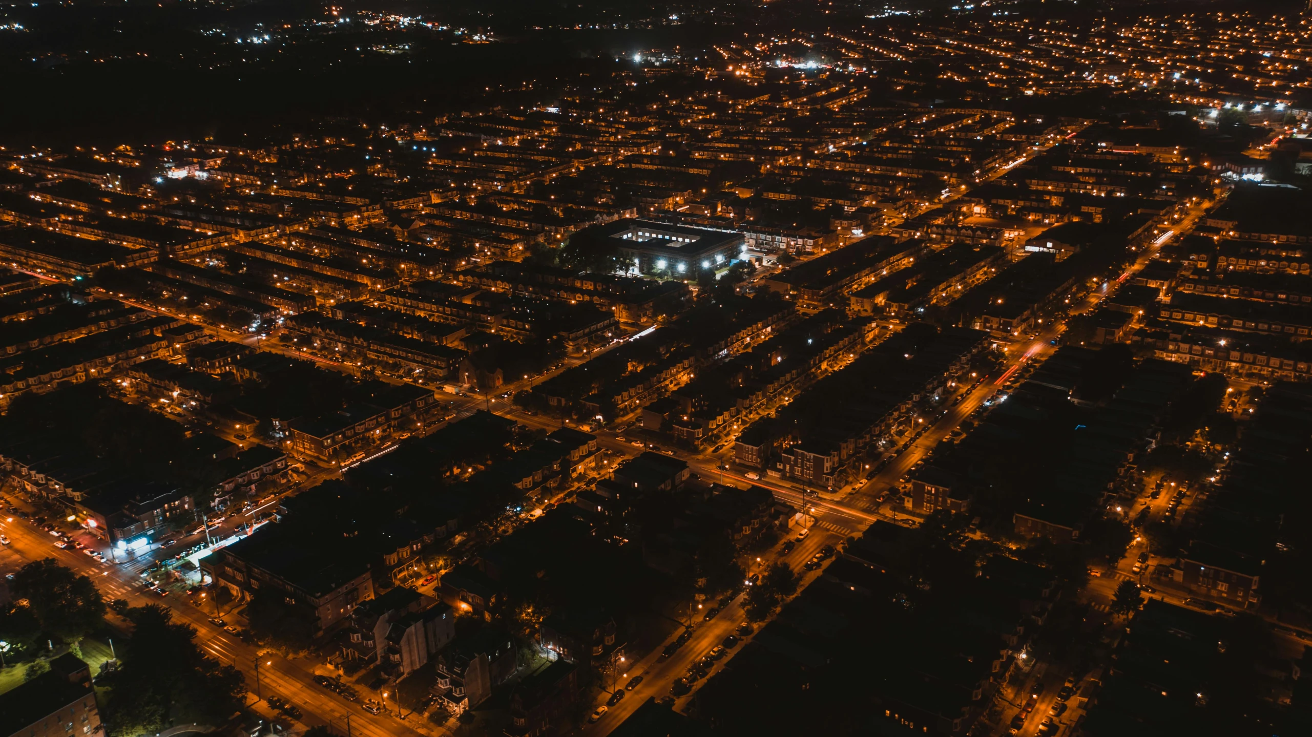 an aerial view of a city at night, by Adam Marczyński, suburbs, tourist photo, rectangle, high res 8k