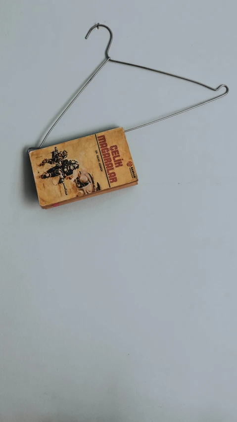 a close up of a mousetrace on a white surface, an album cover, by Tony Tuckson, unsplash, red dead redemption 2, sci fi necklace, wooden casing, high quality photo