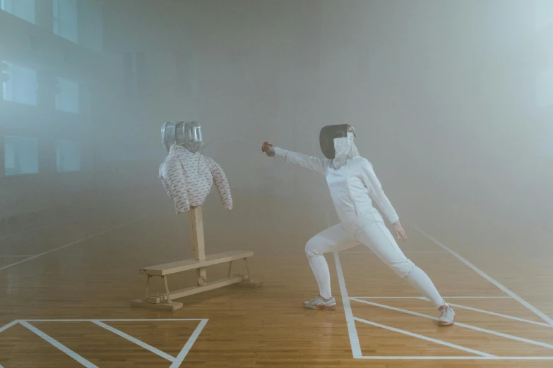 a couple of people standing on top of a wooden floor, unsplash contest winner, interactive art, fencing, full body robot with human mask, ( ( theatrical ) ), white fog