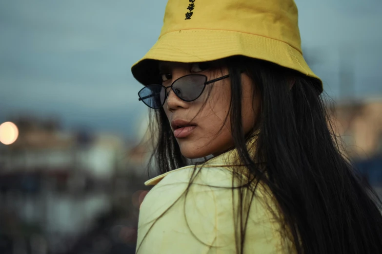 a woman wearing a yellow hat and sunglasses, trending on pexels, half asian, edgy, avatar image, streetwear