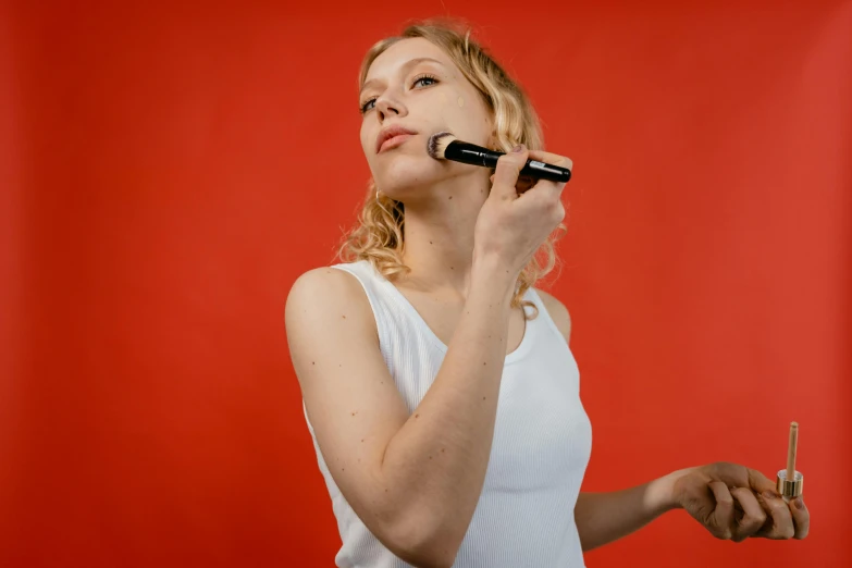 a woman brushes her teeth in front of a red background, by Julia Pishtar, trending on pexels, hyperrealism, round chin black eyeliner, isolated on white background, pale - skinned, promotional image