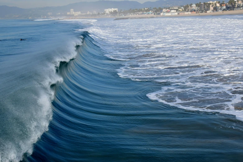 a man riding a wave on top of a surfboard, by Leo Michelson, pexels contest winner, renaissance, santa monica beach, panoramic photography, ripples, ::