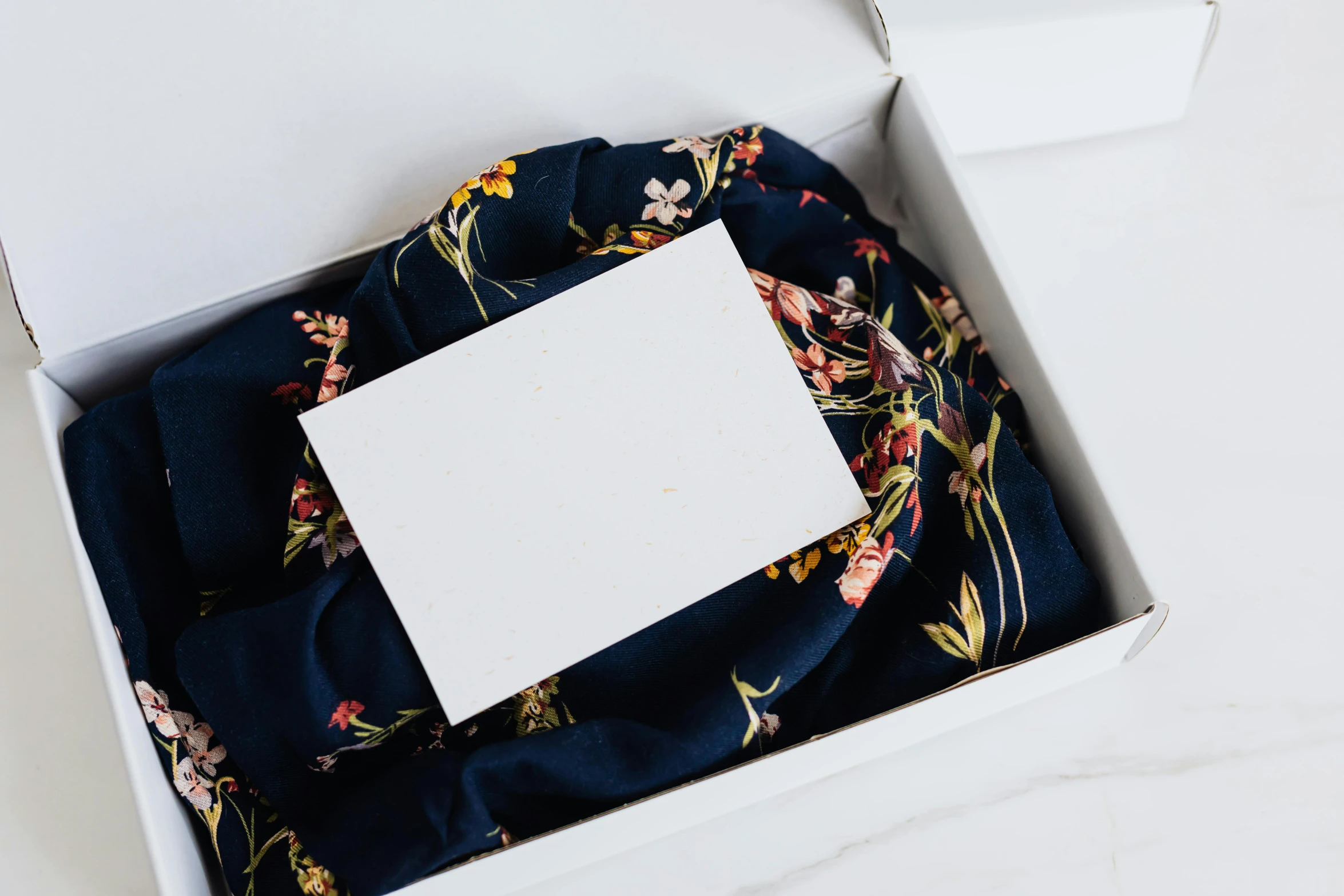 a box that has a piece of paper in it, inspired by Eden Box, unsplash, floral clothes, shawl, navy, random things