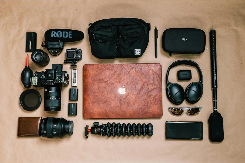 a variety of electronics laid out on a table, a still life, by Carey Morris, unsplash, sony a7r iii, traveller, laptops, cinematic outfit photo