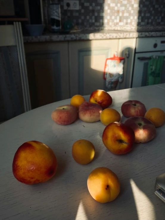 apples and oranges on a table in a kitchen, inspired by Elsa Bleda, unsplash, hyperrealism, poor quality, sun behind her, low quality photo, peaches