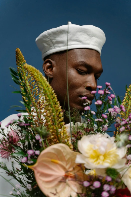 a man in a sailor's hat holding a bouquet of flowers, an album cover, inspired by Barthélemy Menn, trending on unsplash, playboi carti portrait, edible flowers, chef hat, serene expression