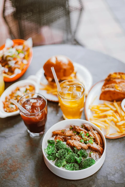 a table topped with plates of food and drinks, by Austin English, french fries, baked beans, los angeles, profile image