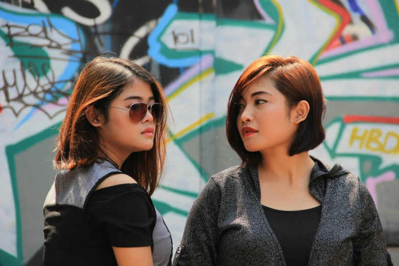 a couple of women standing next to each other, pexels contest winner, realism, in style of thawan duchanee, shady look, malaysian, profile image