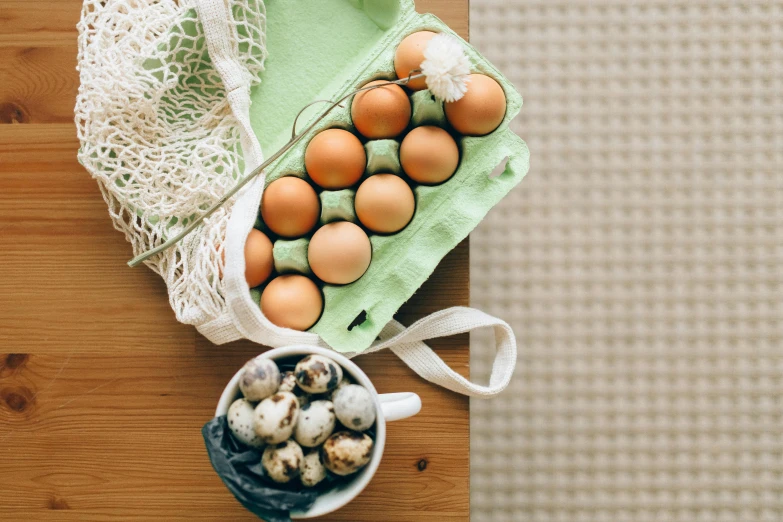 a bag of eggs sitting on top of a wooden table, a still life, by Sylvia Wishart, trending on unsplash, cups and balls, cookbook photo, green pupills, on a wooden tray