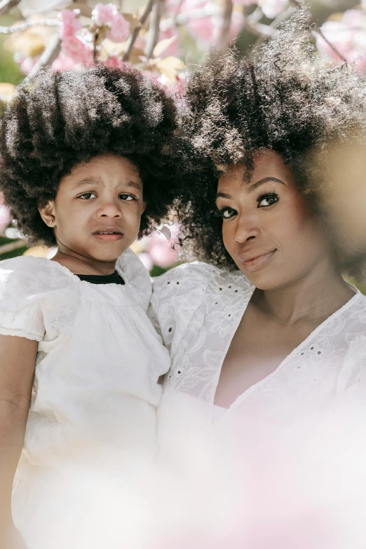 a woman and a child pose for a picture, an album cover, pexels contest winner, natural hair, white hue, portrait image, square