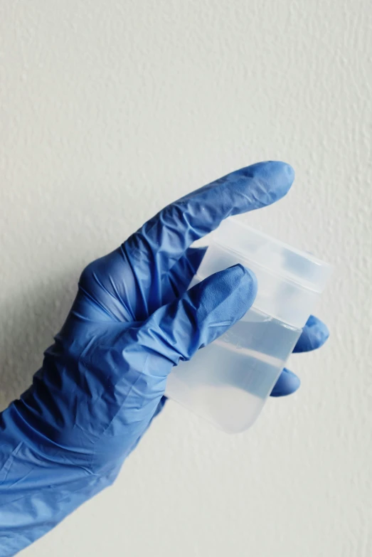 a person in blue gloves holding a plastic cup, soft opalescent membranes, high samples, less detailing, muscle tissue