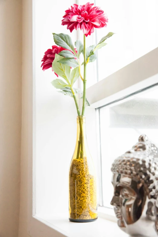 a vase filled with pink flowers sitting on a window sill, inspired by Frida Kahlo, yellow and red, beautiful intricate glass bottle, large tall, product display photograph