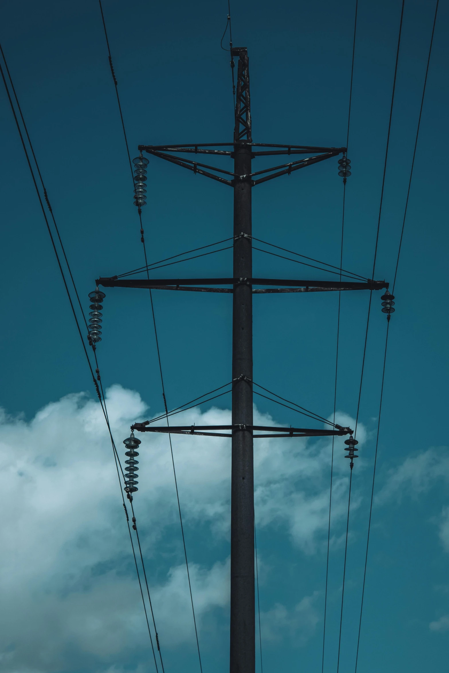 power lines against a blue sky with clouds, by Sven Erixson, unsplash, low detail, dsrl photo, towering, blue and black