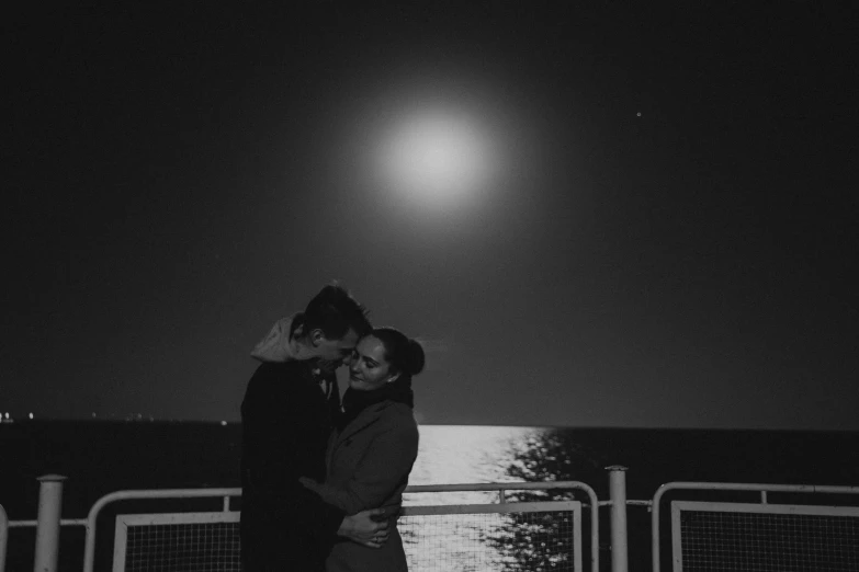 a black and white photo of a couple kissing in front of the moon, by Emma Andijewska, tumblr, the night sky is a sea, photo taken with sony a7r, 🌸 🌼 💮, led