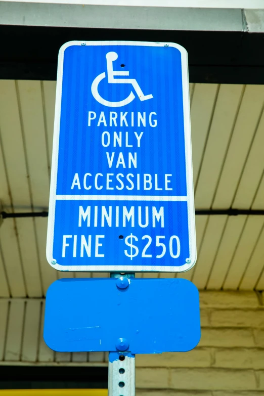 a blue sign sitting on the side of a building, a stipple, parking lot, wheelchair, insanely fine detail, van