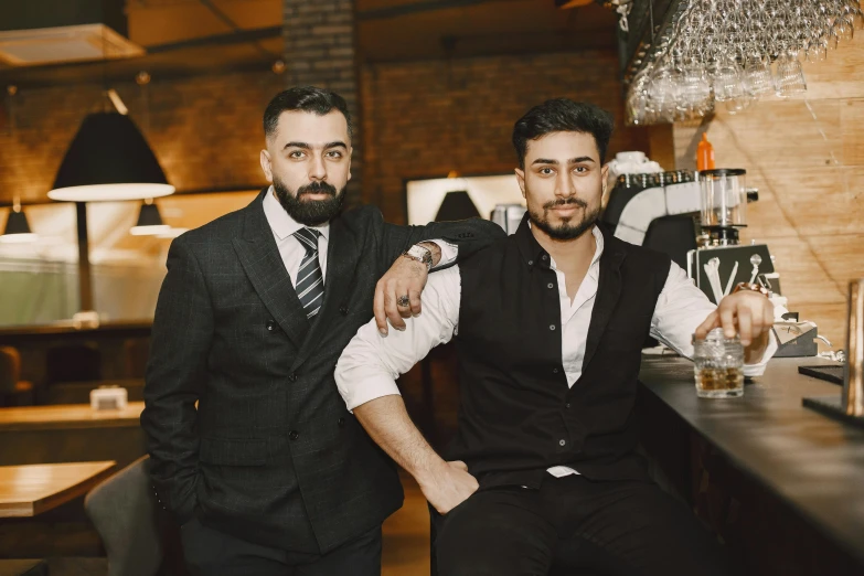 two men standing next to each other at a bar, a portrait, by Emma Andijewska, pexels contest winner, middle eastern style vendors, avatar image, well-groomed model, assyrian