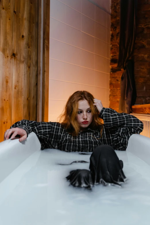 a woman sitting in a bathtub with her hands on her head, inspired by Elsa Bleda, trending on pexels, renaissance, white blouse and gothic boots, sad christina hendricks, in a cabin, bubbly