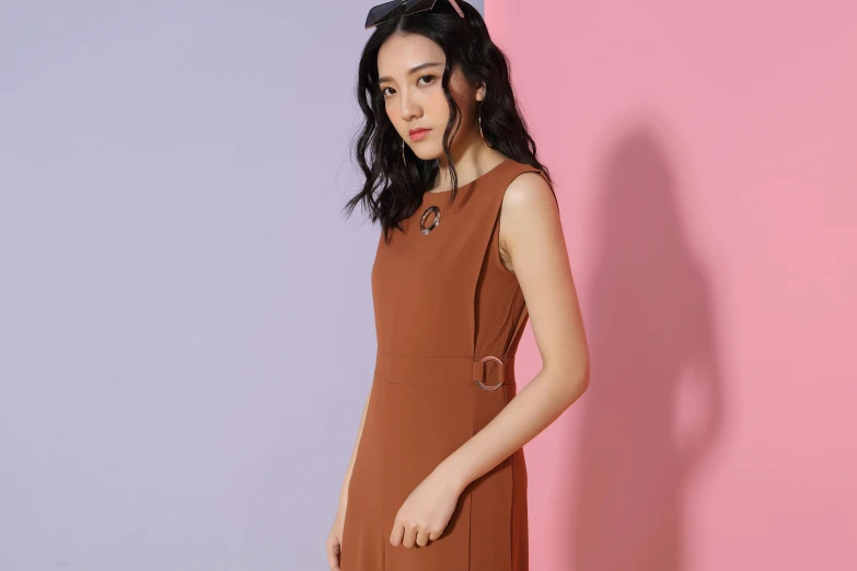 a woman standing in front of a pink and blue wall, inspired by Tang Di, minimalism, in lace brown dress, official store photo, brown:-2, orange hue