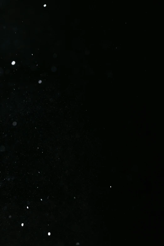 a man flying through the air while riding a snowboard, by Cornelis Verbeeck, unsplash, hurufiyya, webcam screenshot, white with black spots, raining! nighttime, desolate :: long shot