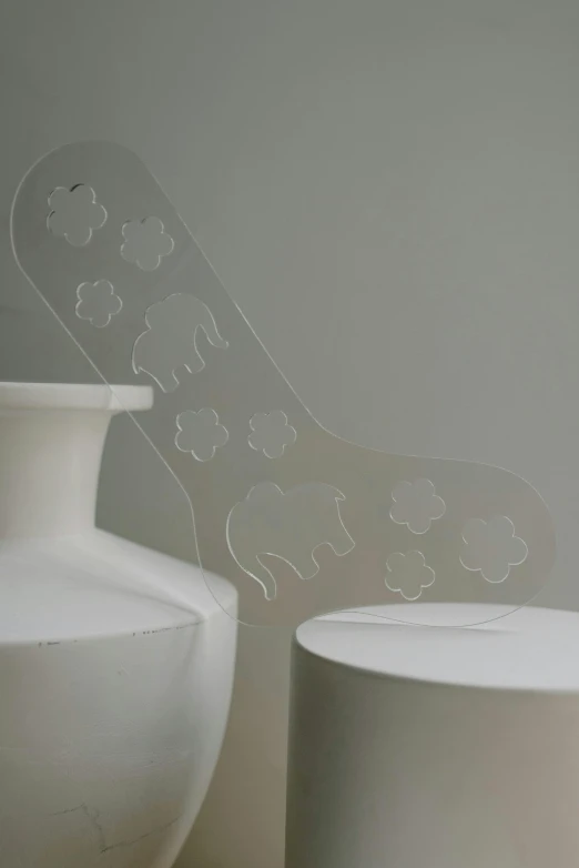 a couple of white vases sitting next to each other, inspired by Rachel Whiteread, plasticien, detailed foot shot, clear silhouette, elephants, laser cut